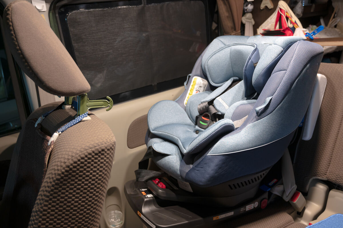 An approved child seat fitted and buckled into the back of a taxi