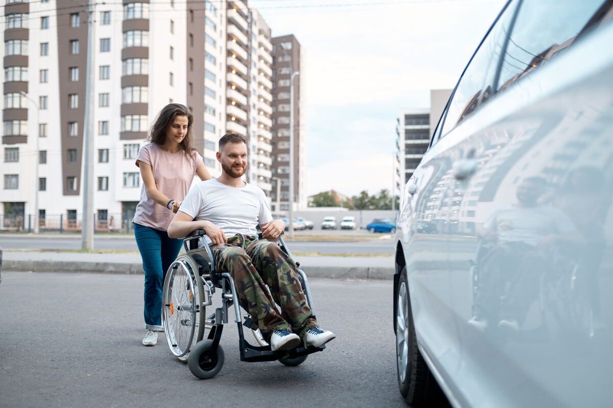 A participant and their companion arriving at a waiting vehicle