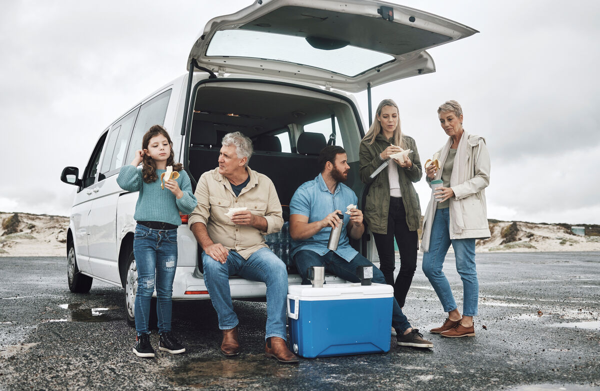Three generations of a family loading a maxi taxi together
