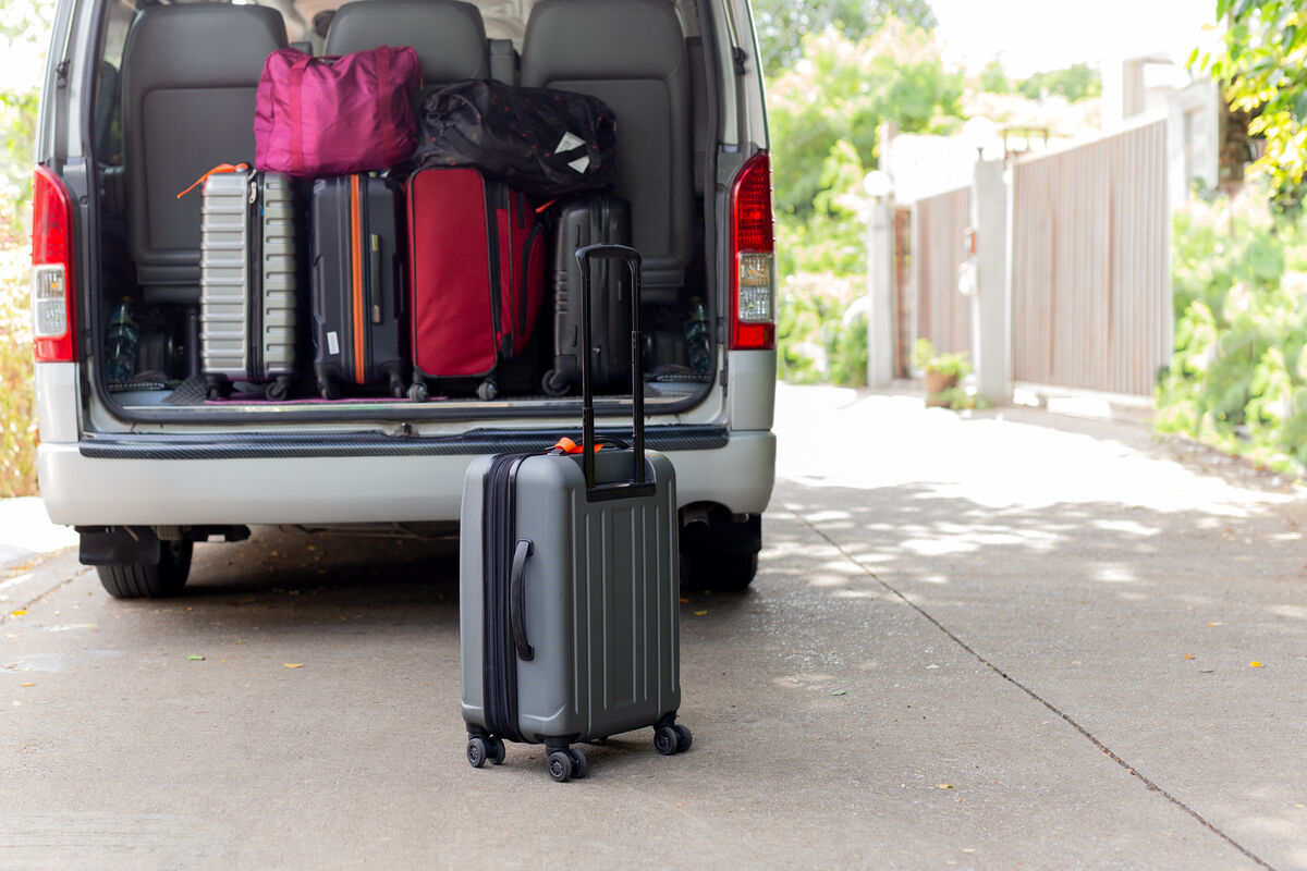 The rear of a maxi taxi loaded with suitcases