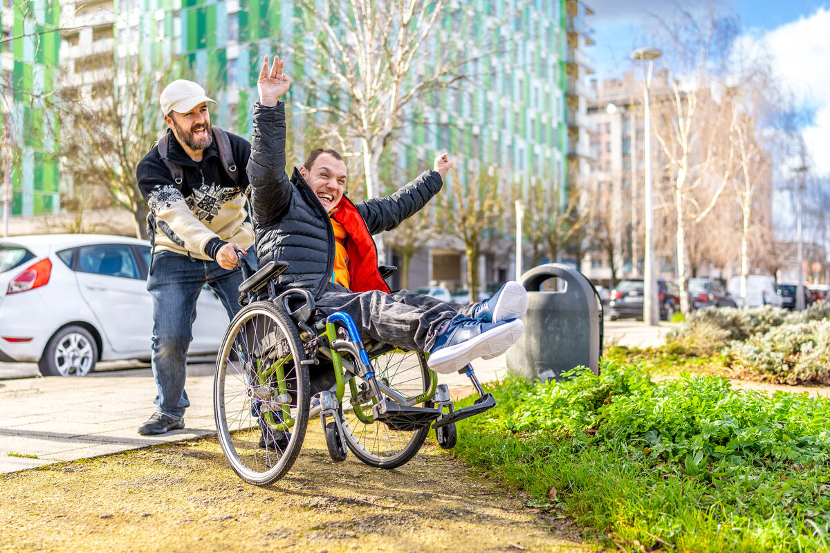 A support worker and a participant out on a city street together