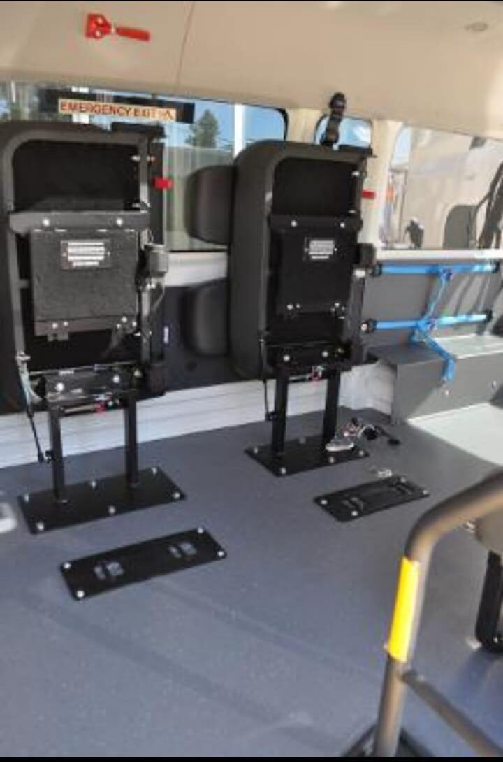 Floor anchor points and fold-away seats inside a wheelchair-accessible maxi cab