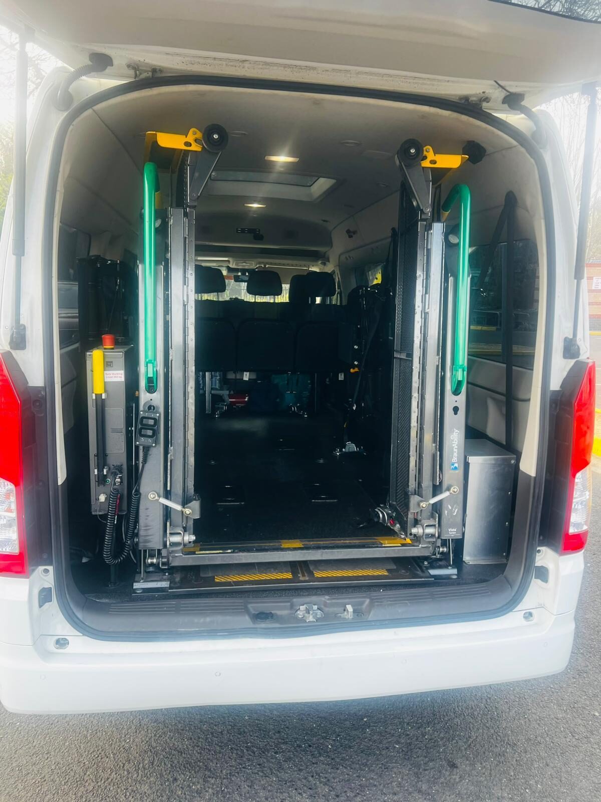 Rear doors open on a wheelchair-accessible van with the twin-post lift folded away