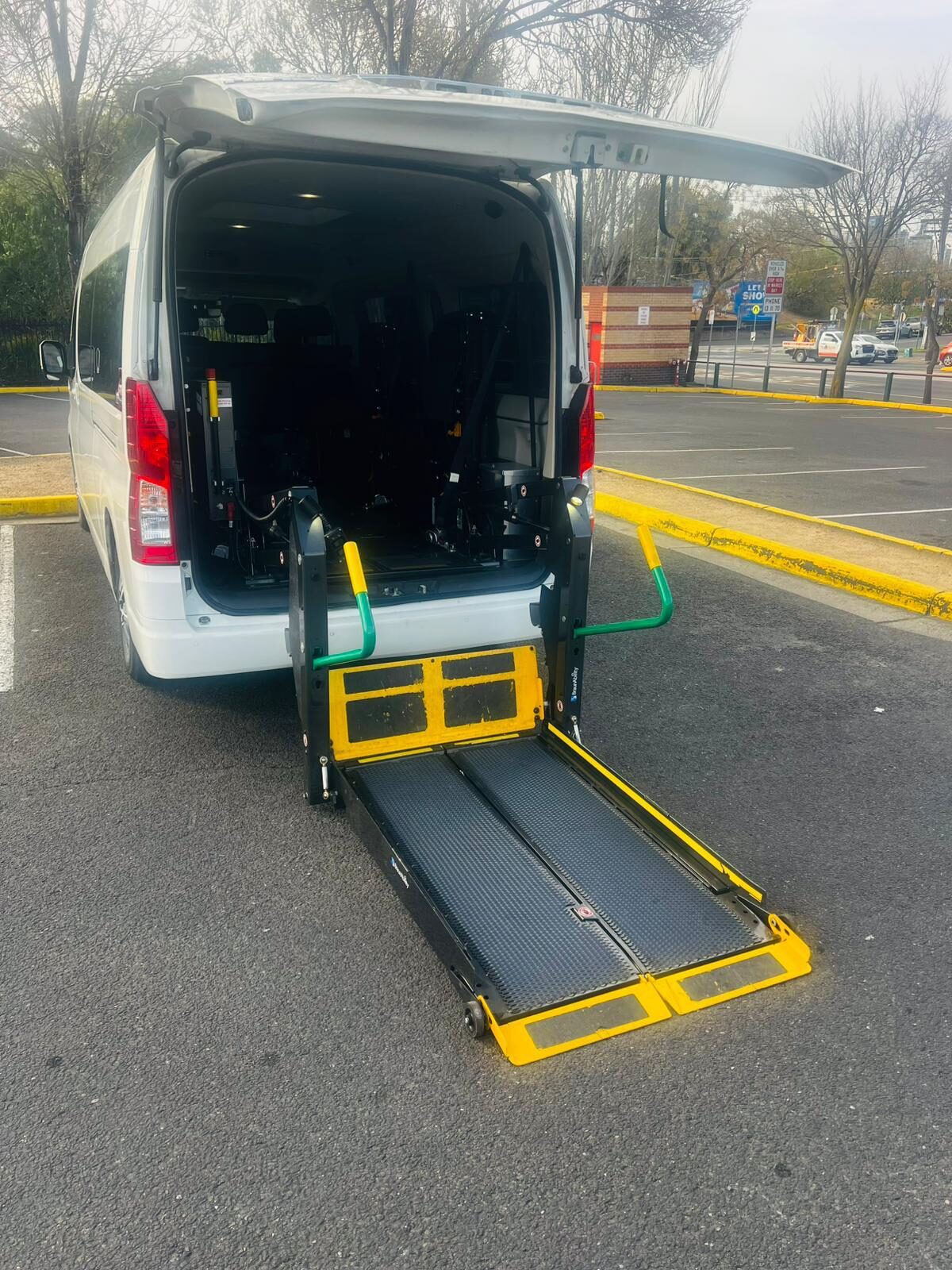 A Quick Maxi Cab wheelchair-accessible van with its rear ramp lowered