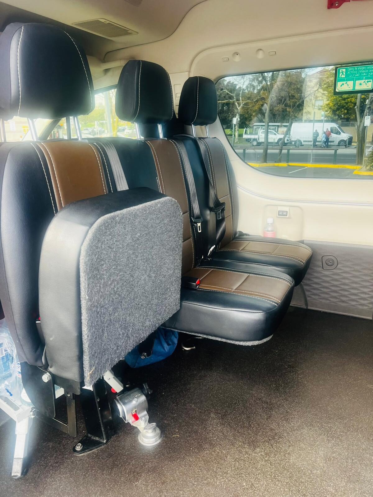 Passenger seating and restraint hardware inside a wheelchair-accessible maxi cab